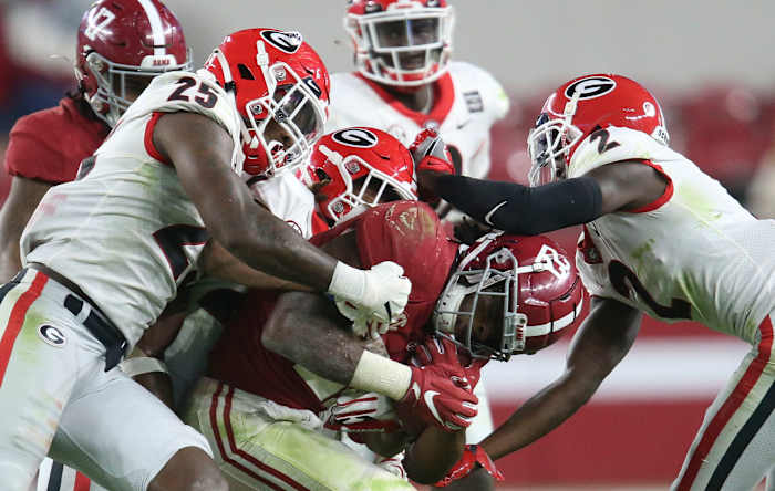 Oct 17, 2020; Tuscaloosa, Alabama, USA; Georgia defenders swarm Alabama running back Najee Harris (22) as he runs the ball during the second half of Alabama's 41-24 win over Georgia at Bryant-Denny Stadium.